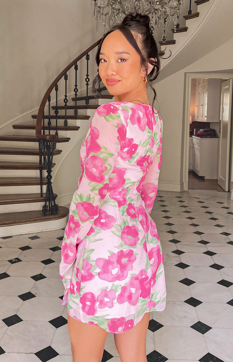 Close-up of the pink floral print fabric with green leaves, showing the ruched side panel and delicate drawstring ties