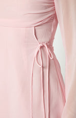 Close-up of the side drawstring ties and cutout detail on a baby pink mini dress