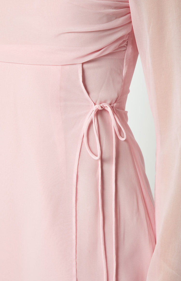 Close-up of the side drawstring ties and cutout detail on a baby pink mini dress
