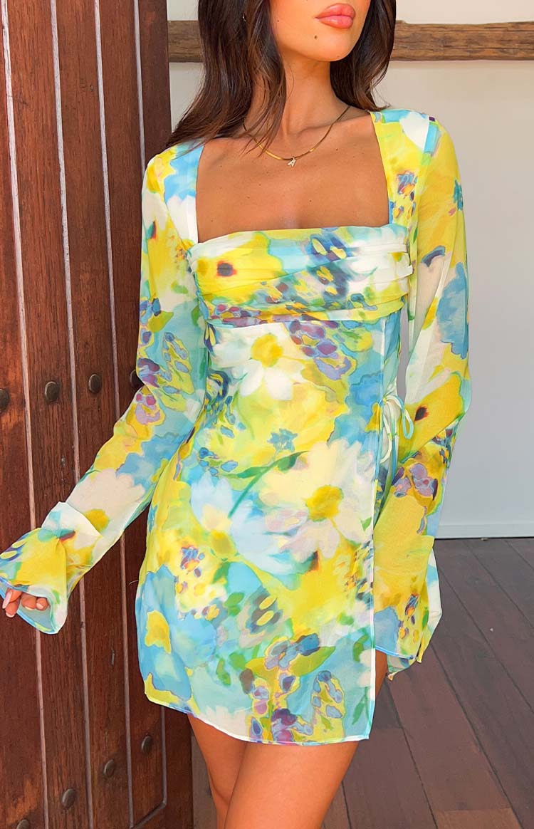 Front view of a blue and yellow floral mini dress with a square neckline and side tie details