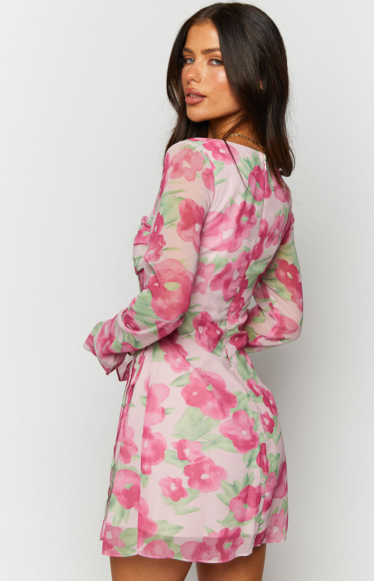 Close-up of the square neckline and side tie detail on a pink floral print long sleeve mini dress