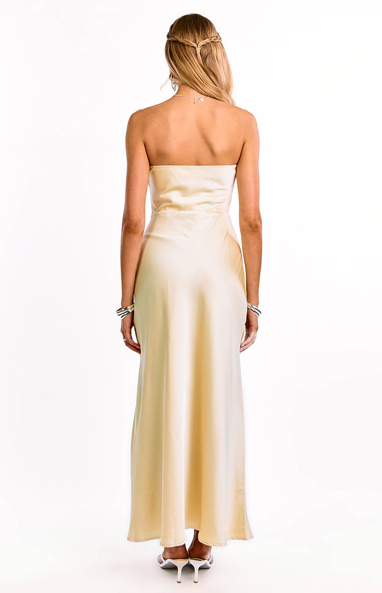 Back view of the yellow strapless maxi dress, highlighting the straight back and the smooth, flowing fabric of the skirt