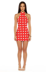 Front view of a red mini dress with white polka dots, featuring a high halter neckline and a sleeveless, bodycon fit