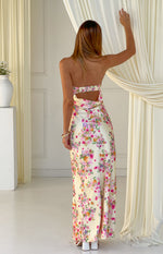 Rear view of a yellow floral satin maxi dress with a strapless cut-out back and shirred elastic band