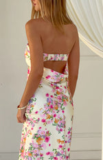 Rear view of a yellow floral maxi dress showing a shirred elastic back band and a draped open back cutout