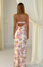 Rear view of a yellow floral strapless maxi dress with a ruched upper back band and cowl drape cutout