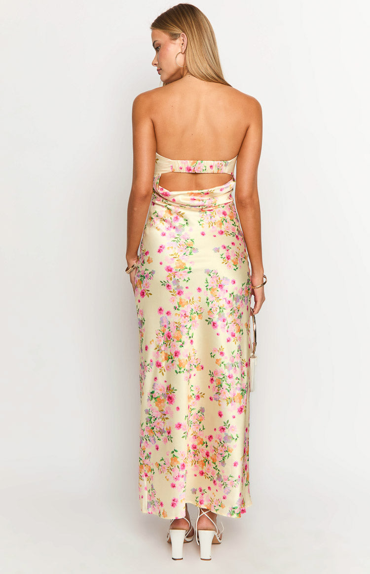 Rear view of a yellow floral maxi dress with a strapless back and waist cutouts