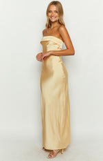 Side view of a yellow satin strapless maxi dress with a folded bandeau neckline