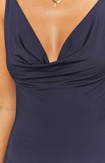 Close-up of the navy maxi dress bodice showing the draped cowl neckline and smooth fabric