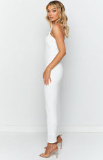 Side view of a fitted white textured maxi dress with thin spaghetti straps
