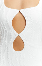 Close-up of the two diamond-shaped cutouts on the white textured fabric of the maxi dress