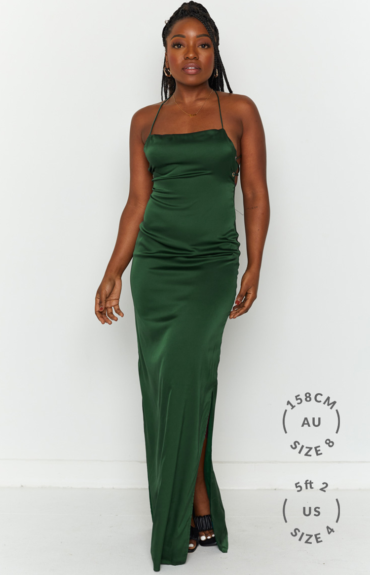 Emerald green satin maxi dress with a straight neckline, thin straps, and lace-up side detail