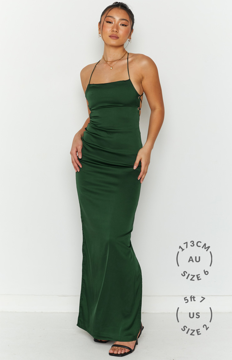 Emerald green satin slip dress with thin straps, gold eyelet lace-up side, and high thigh split