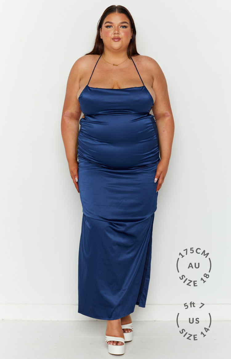 Navy satin maxi dress with cowl neckline, thin halter straps, side cutouts, and ruched detailing