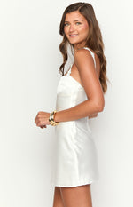 Side view of a white satin mini dress with a fitted bodice and A-line skirt