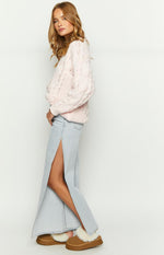 Side view of light wash denim wide leg jeans featuring a prominent high side split