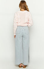 Rear view of light denim wide leg jeans with two back pockets and a side split on the right leg