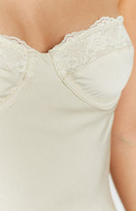 Close-up of the cream lace trim along the neckline and the structured, seamed bust of the midi dress