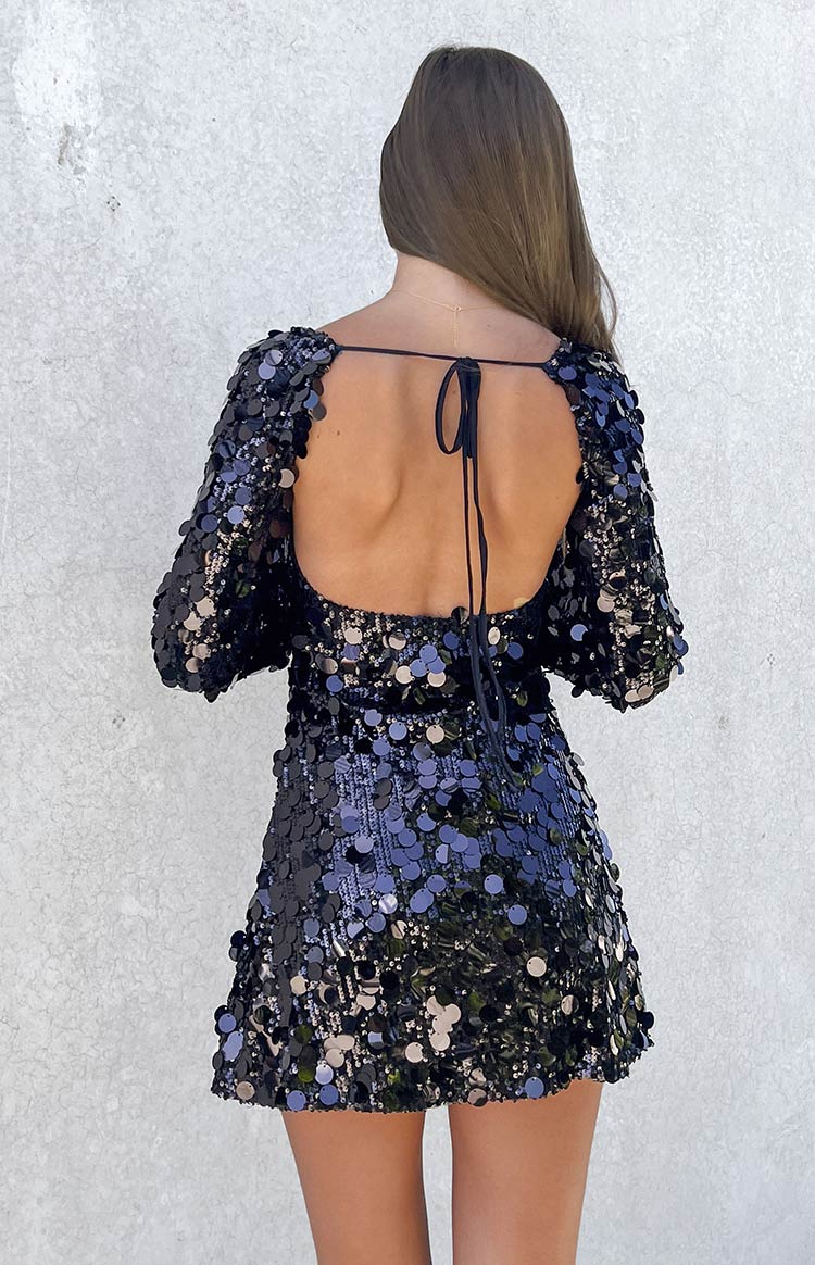 Close-up of the square neckline and large black sequins on the black long sleeve mini dress