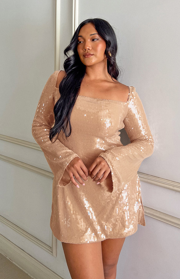 Detail of the champagne sequin fabric, square neckline, and fitted long sleeve