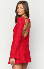 Side view of a red lace mini dress with a low open back, neck tie closure, and long bell sleeves