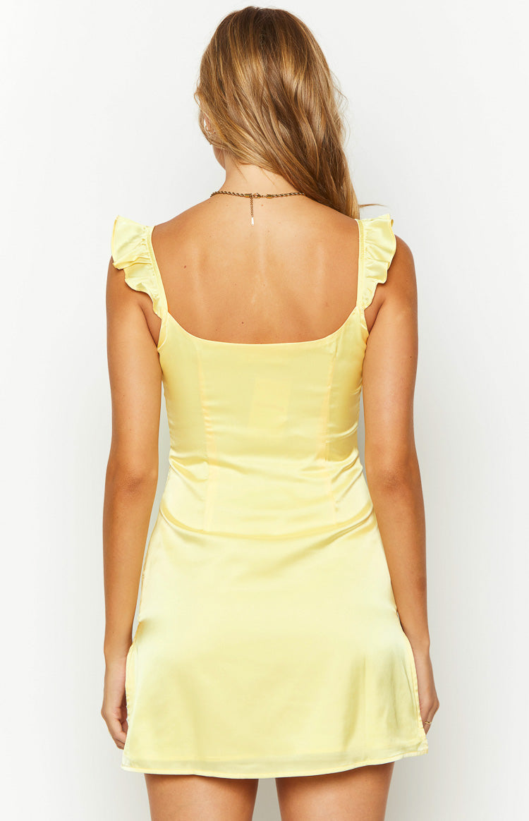 Close-up of the yellow satin mini dress bodice with ruffled straps and side zipper
