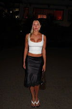 Black satin midi skirt with a subtle A-line silhouette and delicate lace trim at the hem