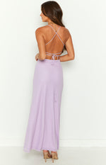 Rear view of a lilac maxi dress with a low scoop back, criss-cross straps, tie detail, and ribbed upper skirt