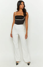 White high-waisted tailored pants with a straight-leg cut and full length