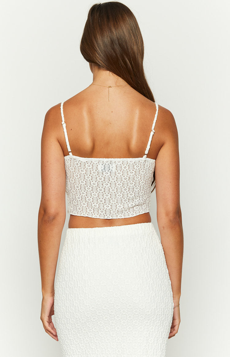 Rear view of the white textured lace crop top with thin spaghetti straps and a square back neckline