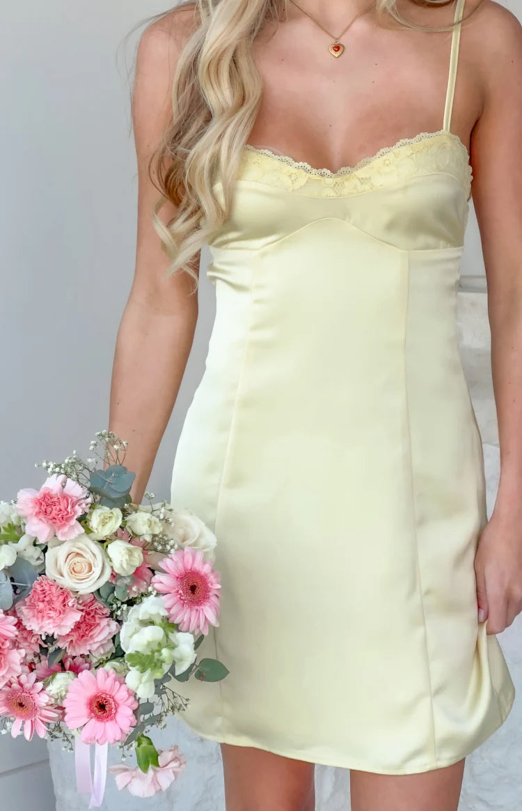 Yellow satin mini dress bodice with delicate lace trim, thin spaghetti straps, and fitted paneling