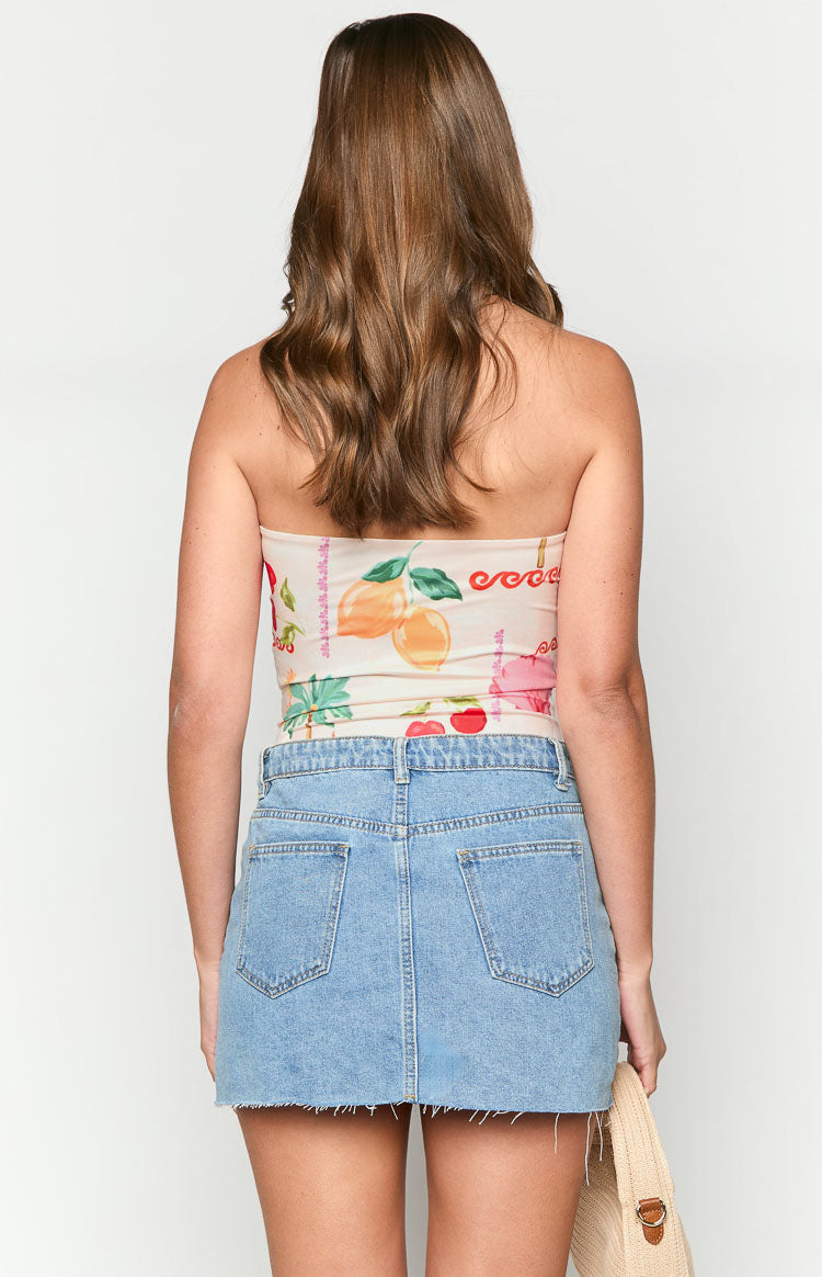 Rear view of a beige strapless bodysuit with a colourful fruit and palm tree print