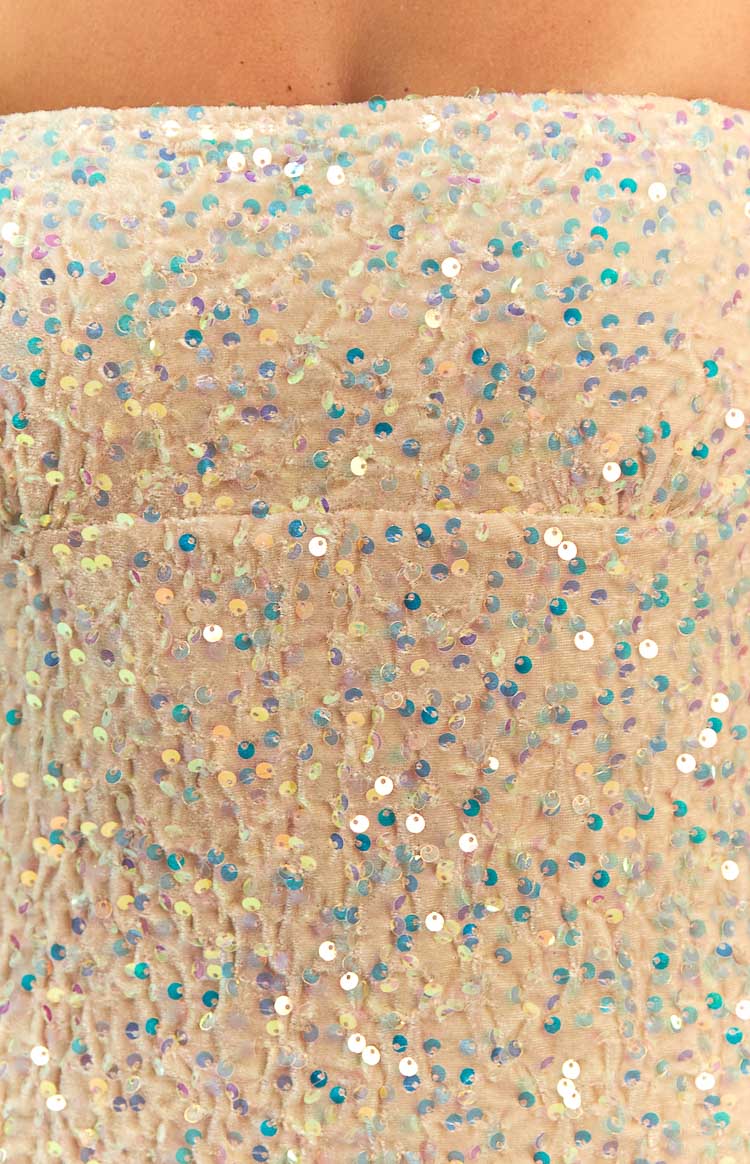 Close-up of a gold sequined strapless maxi dress with thin spaghetti straps and gathered bust