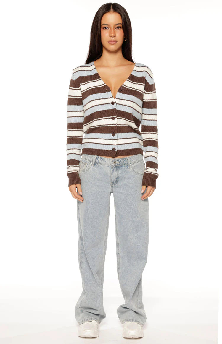 Front view of a brown and blue stripe button down cardigan worn open, showing its relaxed fit