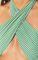 Close-up of the green and white striped criss-cross halter neckline of the bikini top