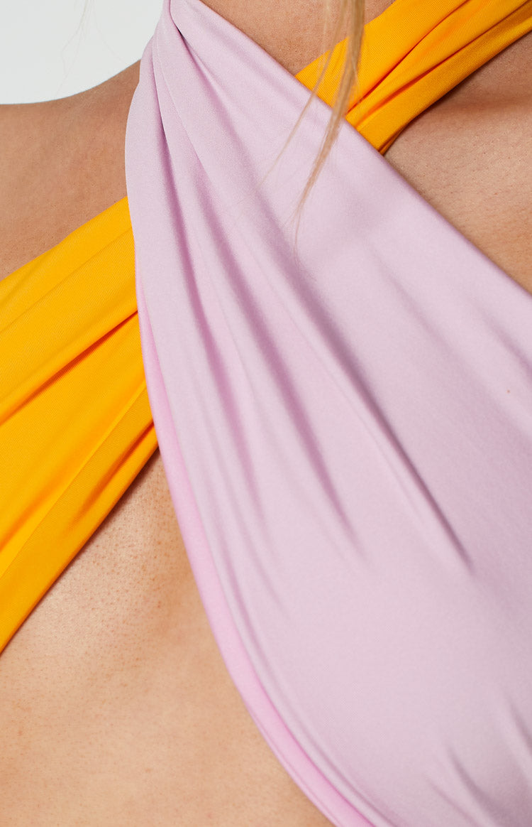 Two-tone orange and lilac wrap-around halter neck crop top