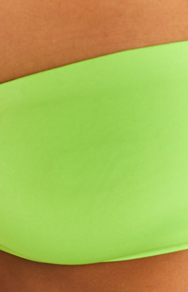 Close-up showing the subtle ribbed texture of the lime green bandeau top fabric