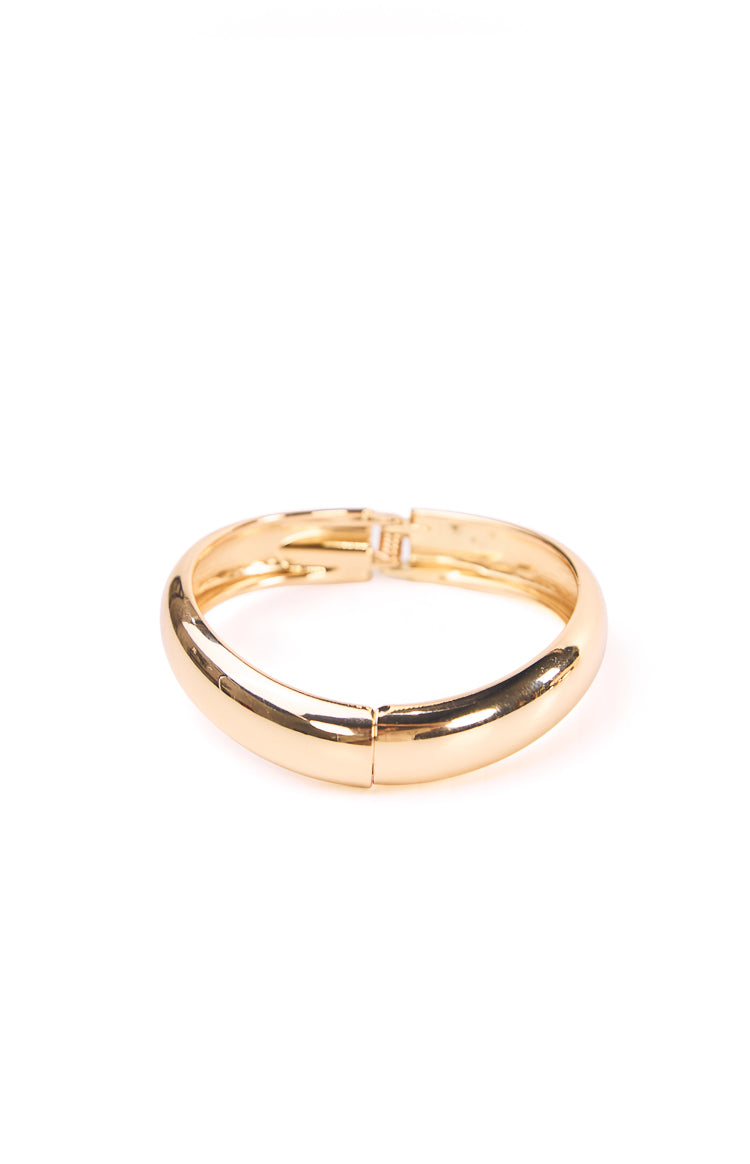 Gold bangle with the clasp open showing the hinge mechanism