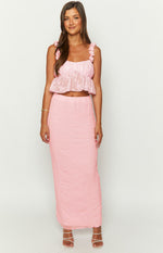 Front view of a pink square neck crop top with shirred bodice, ruffled straps, and a peplum hem in textured floral fabric