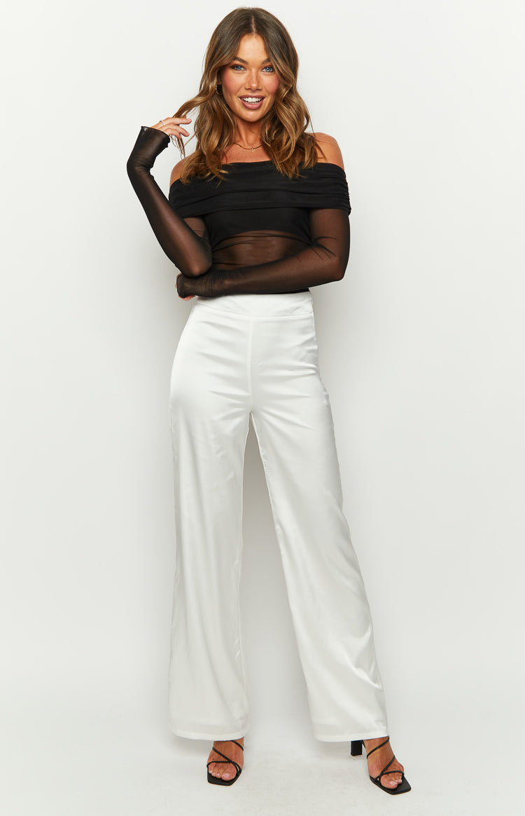 White high-waisted satin pants with a wide-leg silhouette and smooth, flowing fabric