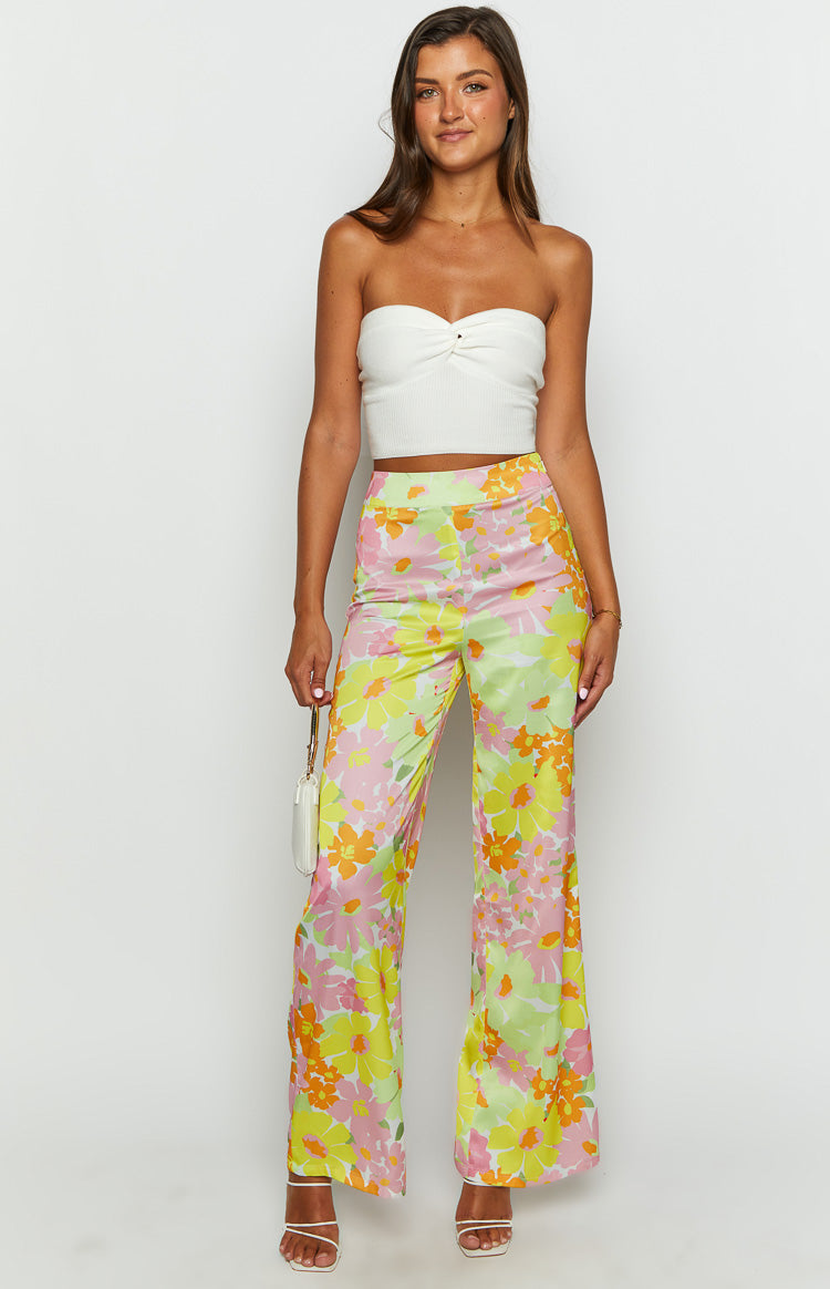 Side view of yellow, orange, and pink floral wide-leg pants with a high waist and flowy fit