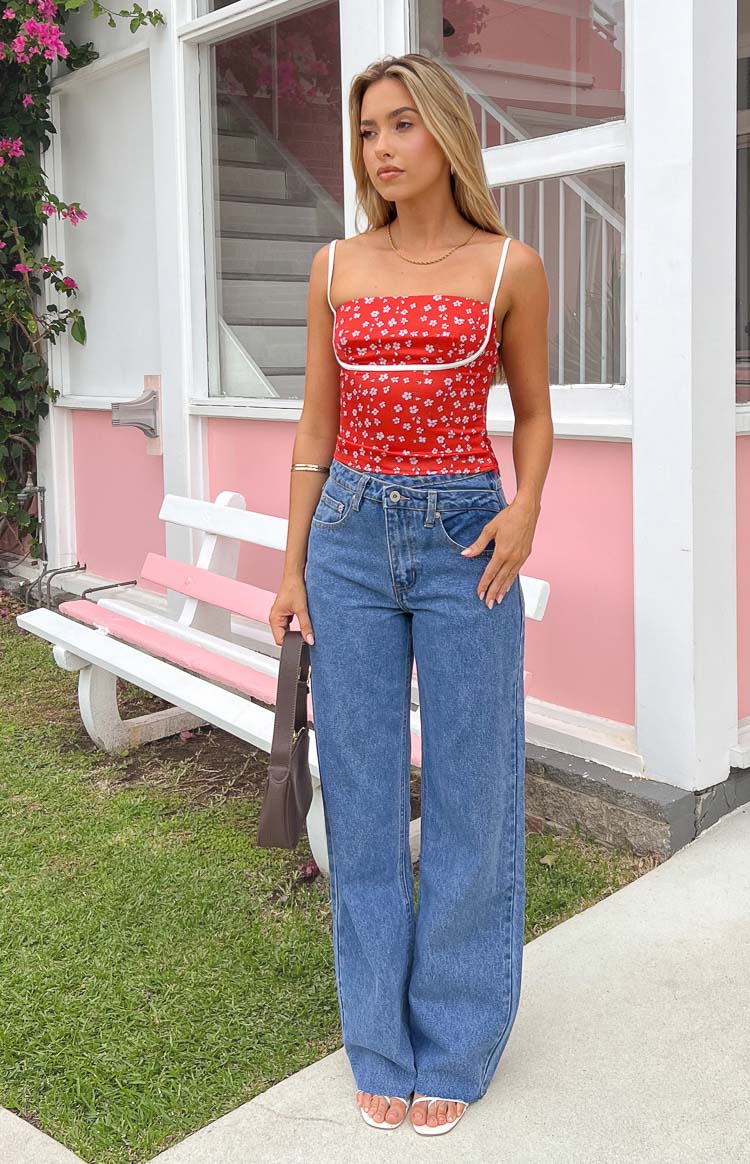 Full length light blue wide-leg jeans with a distressed hem and an uneven high waist