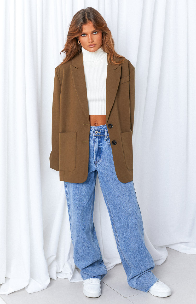 Full length view of blue wide-leg jeans with an uneven waist and relaxed fit