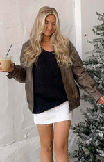 Front view of a black chunky knit sweater, featuring a V-neck and a distinct chunky textured weave