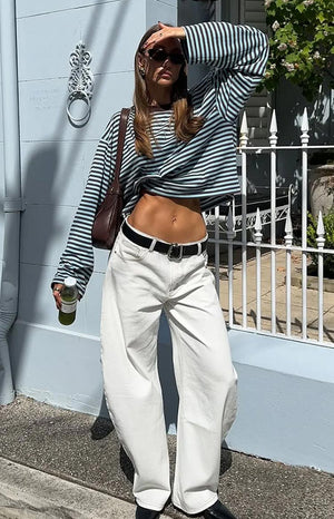 A person wearing a striped long-sleeved shirt