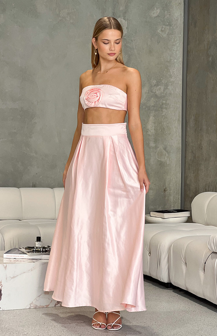 Full length view of a pink satin high-waisted maxi skirt with a wide waistband and soft pleats
