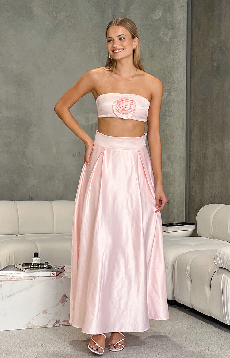 Full front view of a flowy pink satin high-waisted maxi skirt with pleats