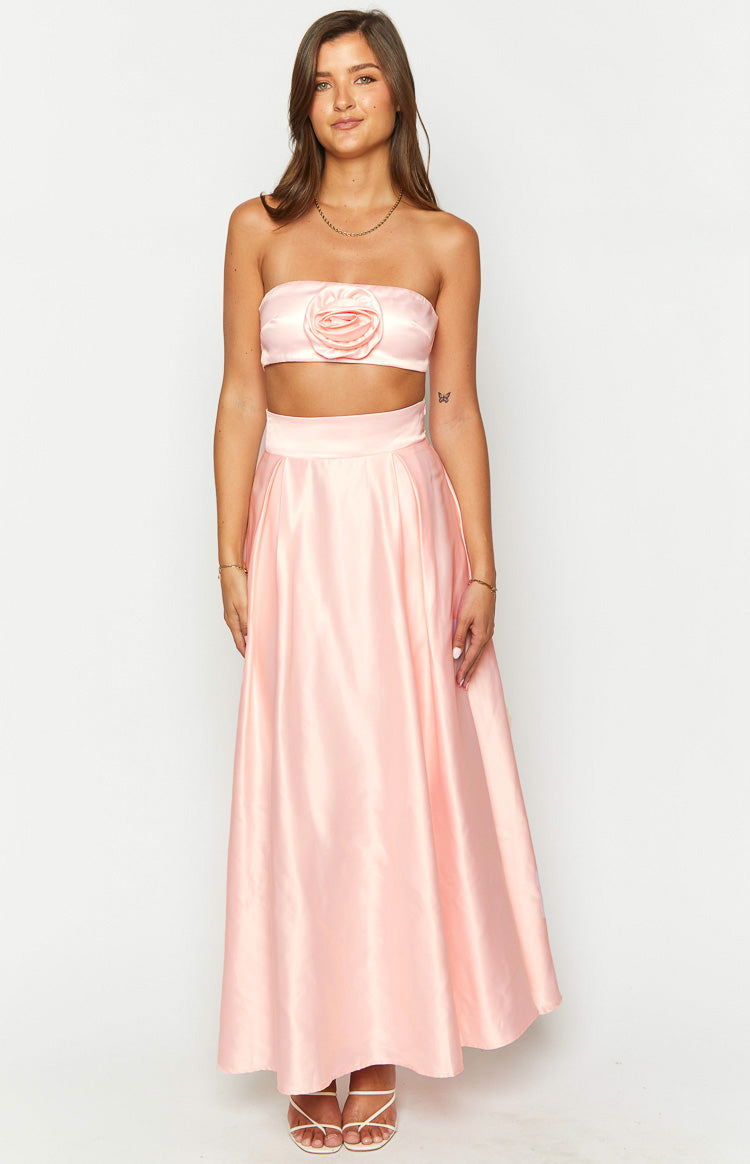 Front view of a pink satin high-waisted maxi skirt with a wide waistband and flowing A-line silhouette