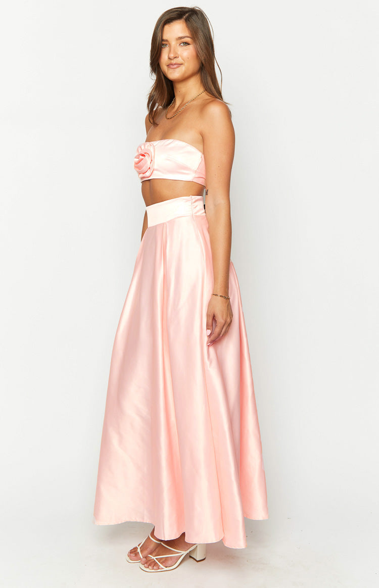 Side view of a pink satin high-waisted maxi skirt with a flowy A-line silhouette