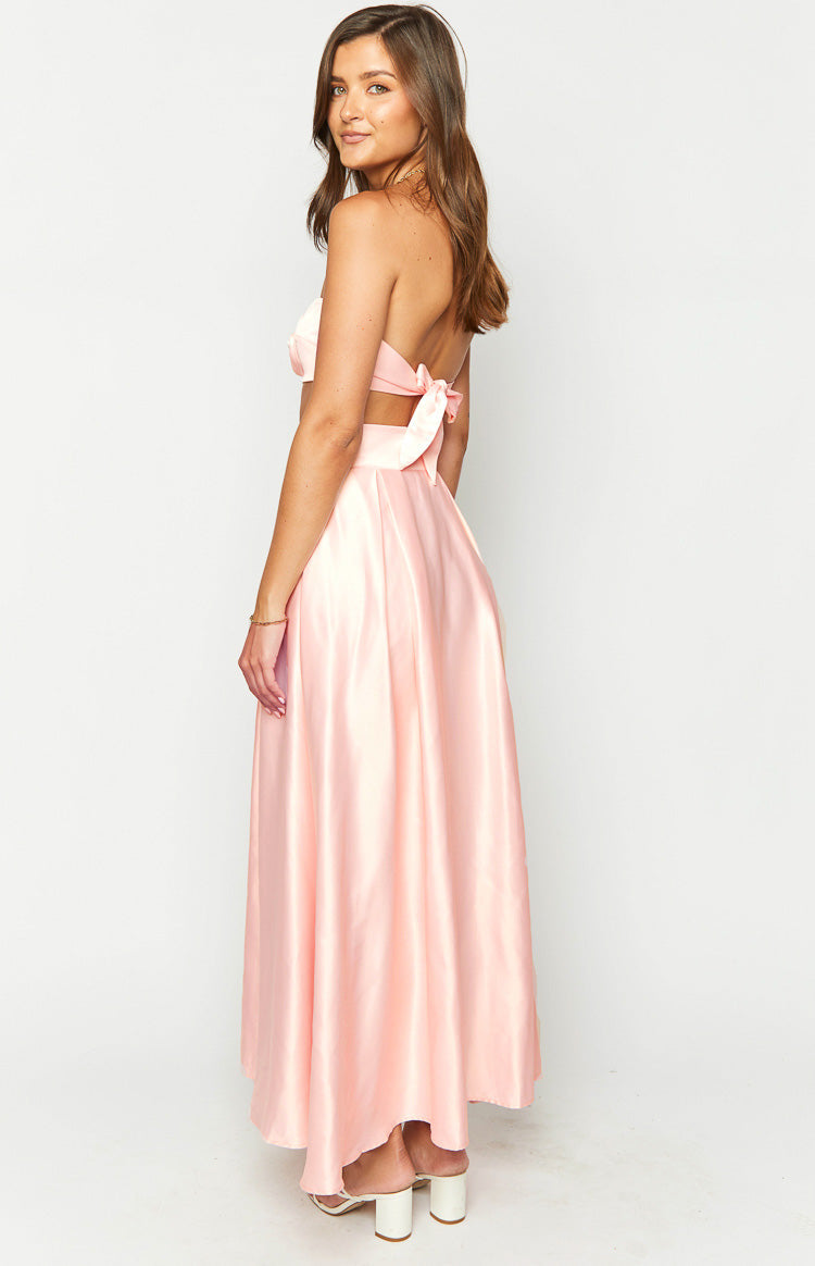 Side view of the pink satin high waisted maxi skirt showing its flowing A-line silhouette